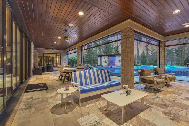 sunroom with a healthy amount of sunlight, wooden ceiling, and ceiling fan