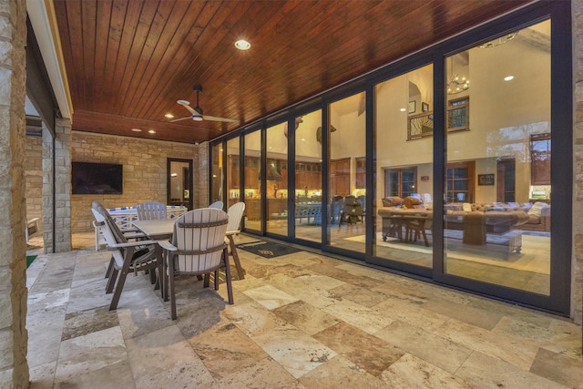 sunroom featuring ceiling fan and wood ceiling