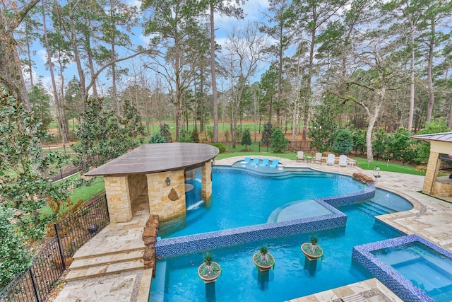 view of pool with an in ground hot tub