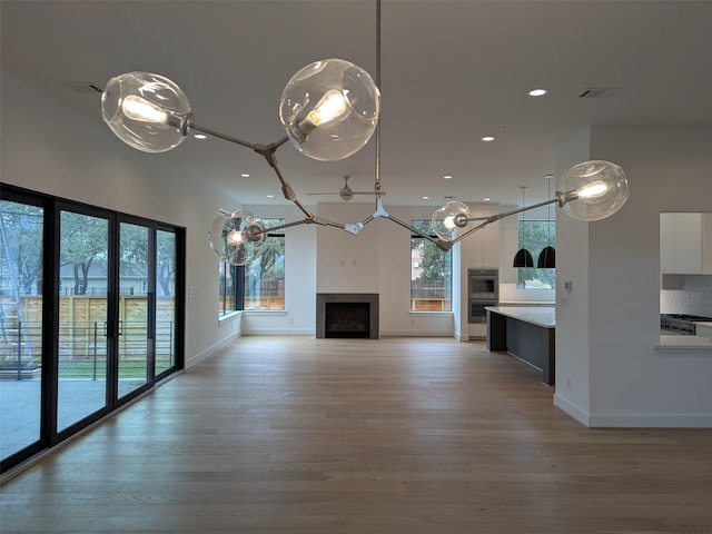 unfurnished living room featuring a healthy amount of sunlight and light wood-type flooring