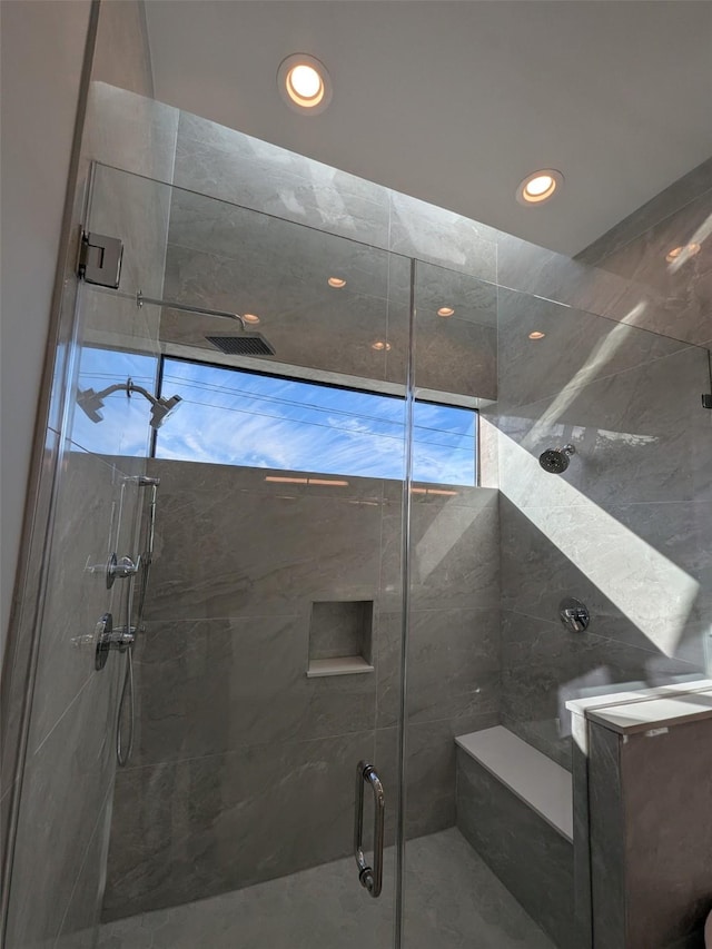 bathroom with a shower with shower door