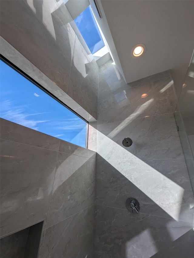 interior details featuring tiled shower