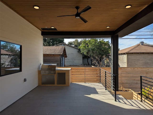 view of patio featuring ceiling fan, an outdoor kitchen, and grilling area