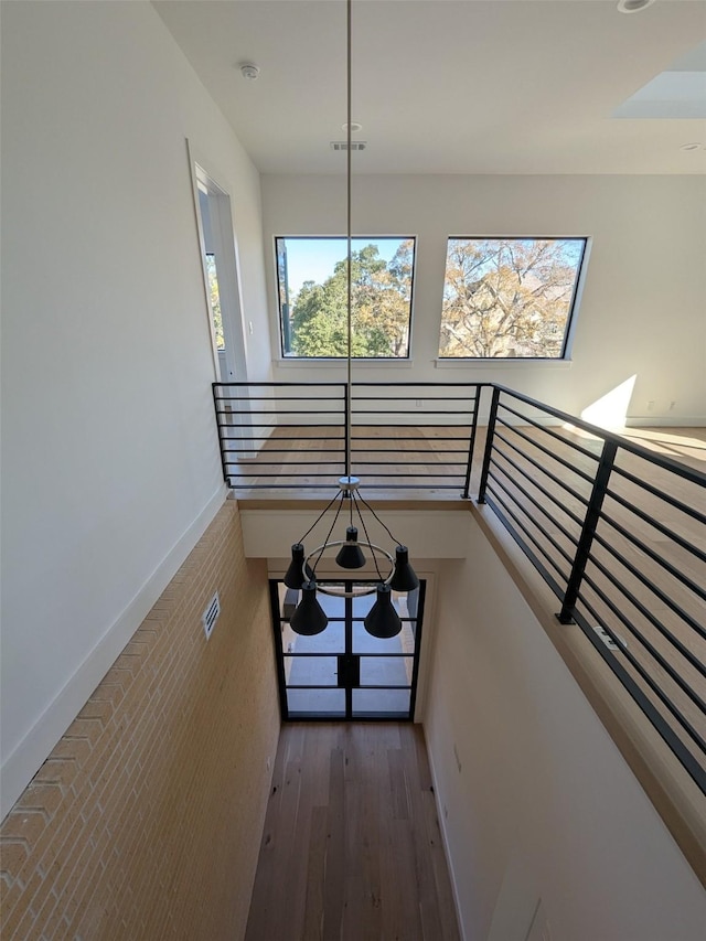 hallway with hardwood / wood-style flooring