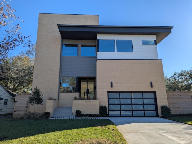 contemporary home featuring a garage and a front yard