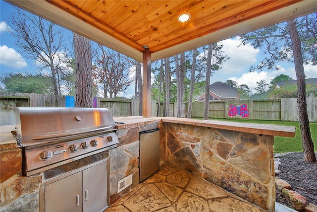 view of patio featuring grilling area and exterior kitchen