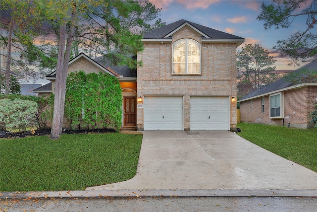 view of front property with a garage and a yard