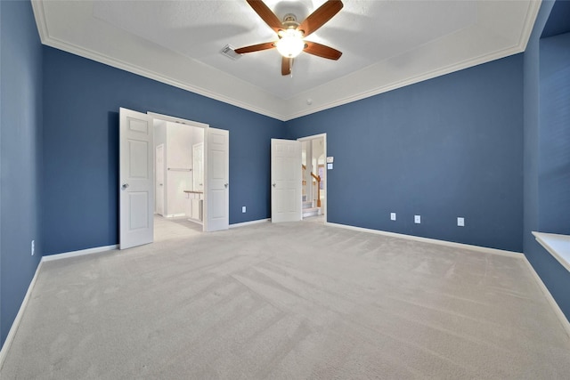 unfurnished bedroom featuring light carpet, crown molding, ceiling fan, and ensuite bathroom