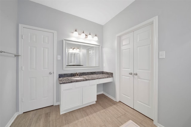 bathroom featuring hardwood / wood-style flooring and vanity