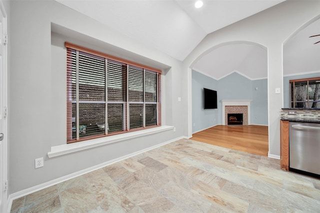 unfurnished living room featuring lofted ceiling and light hardwood / wood-style floors