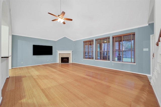 unfurnished living room with vaulted ceiling, ornamental molding, ceiling fan, and light wood-type flooring