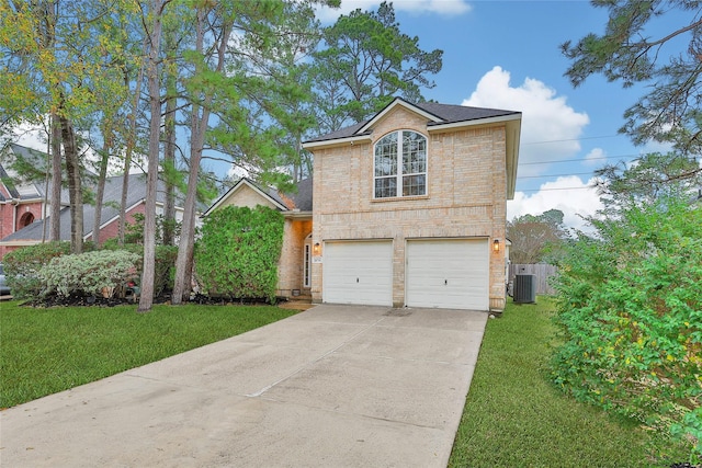 view of front of home with a garage, central AC, and a front lawn