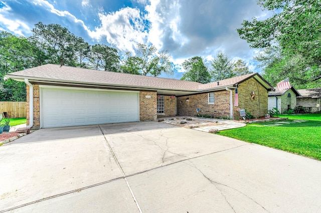 ranch-style home featuring a garage and a front lawn