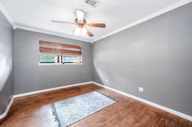 empty room featuring hardwood / wood-style flooring, ceiling fan, and crown molding