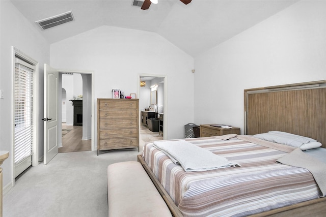 bedroom with vaulted ceiling, light colored carpet, and ceiling fan