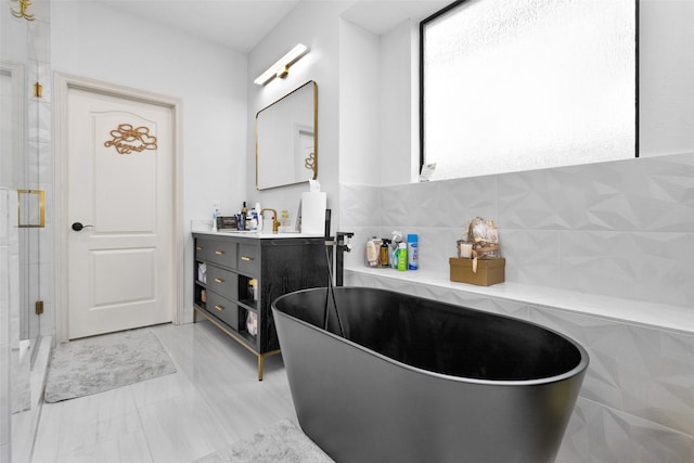 bathroom with vanity and a bath