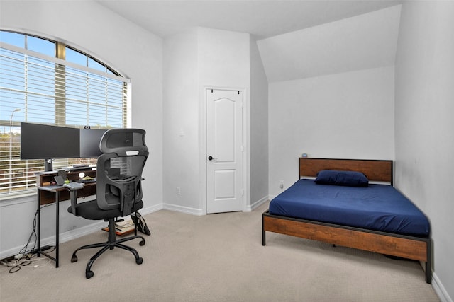 carpeted bedroom with lofted ceiling