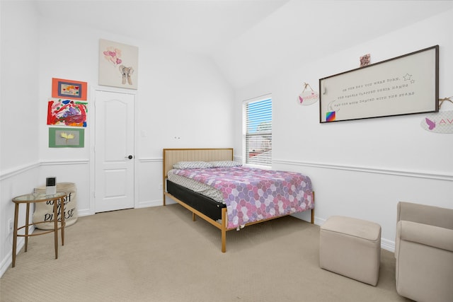 bedroom with vaulted ceiling and light colored carpet