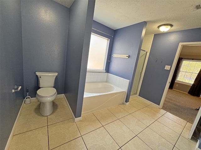 bathroom featuring tile patterned floors, toilet, independent shower and bath, and a textured ceiling