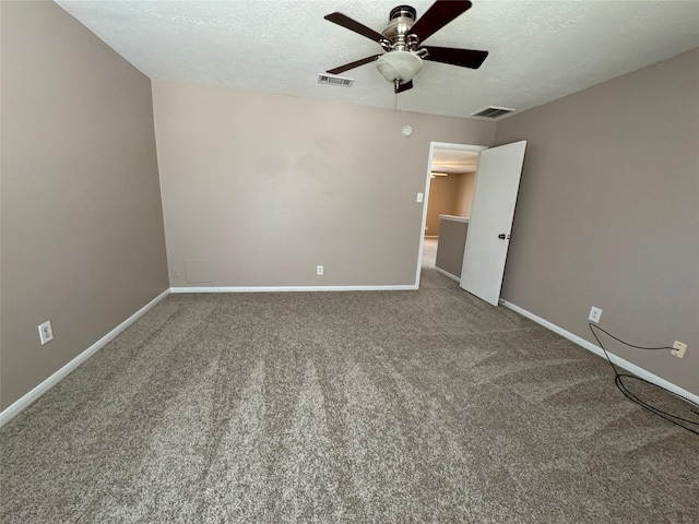 carpeted spare room with ceiling fan and a textured ceiling