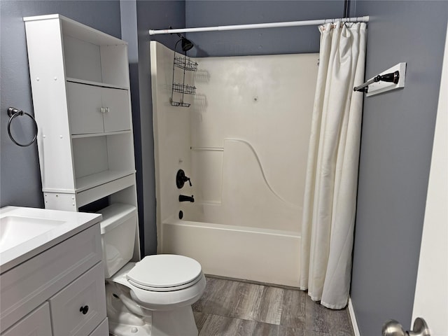 full bath with toilet, vanity, wood finished floors, and shower / tub combo with curtain