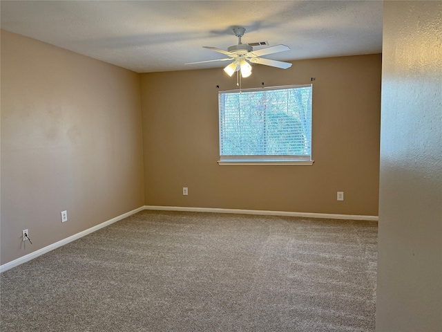 empty room featuring carpet flooring, a textured ceiling, and ceiling fan