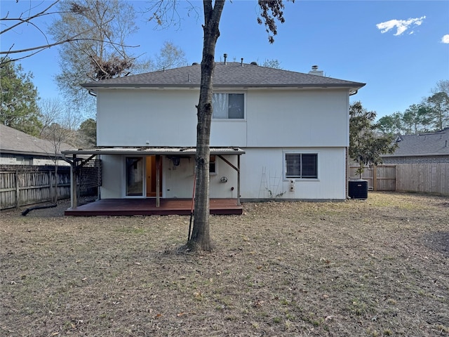 rear view of property with a fenced backyard and cooling unit