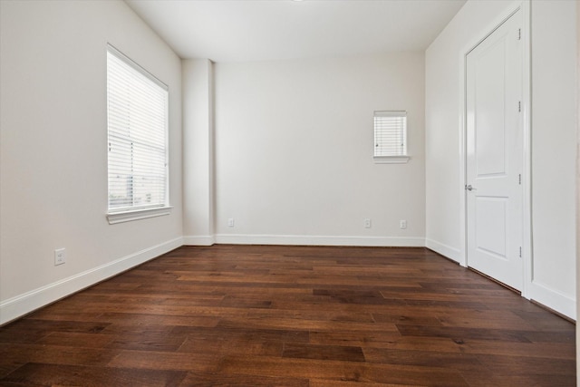 spare room with dark wood-type flooring