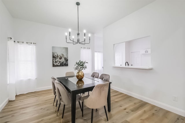 dining area featuring a chandelier and light hardwood / wood-style flooring