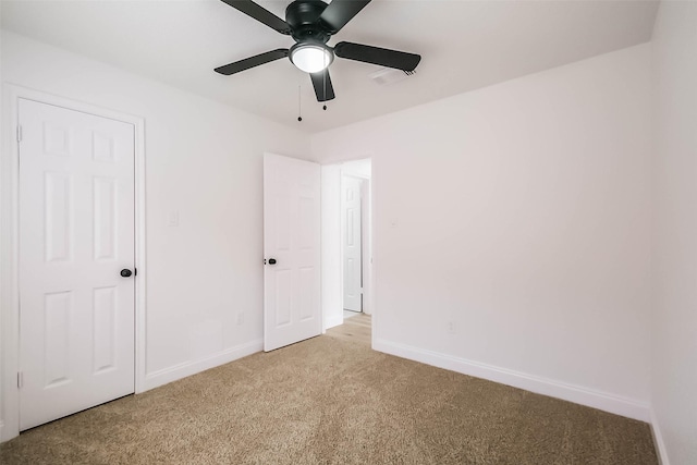 unfurnished bedroom with light carpet and ceiling fan