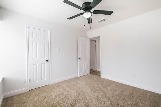 unfurnished bedroom featuring ceiling fan and carpet floors