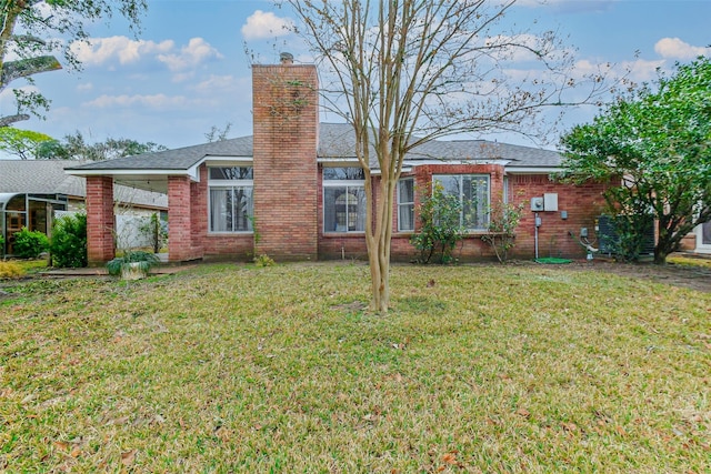 rear view of property with a lawn