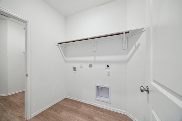 14231 Walworth Creek Ct, Rosharon, TX 77583 - laundry room with hookup for a gas dryer, hookup for an electric dryer, light wood-type flooring, washer hookup, and baseboards