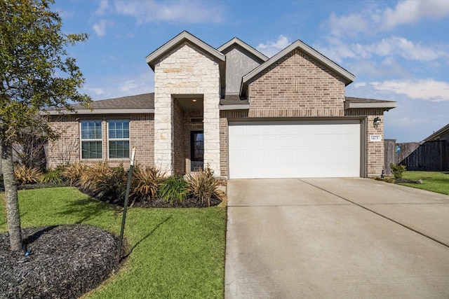 view of front of home with a garage and a front lawn