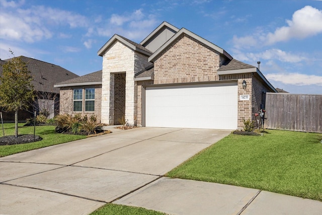 view of front of house featuring a front lawn and a garage