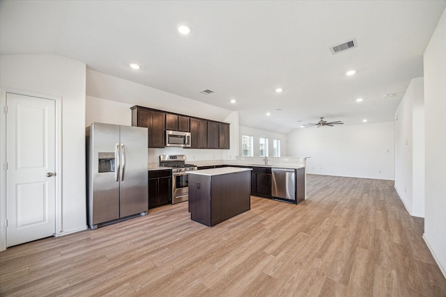 14231 Walworth Creek Ct, Rosharon, TX 77583 - kitchen with appliances with stainless steel finishes, a sink, a center island, open floor plan, and dark brown cabinets