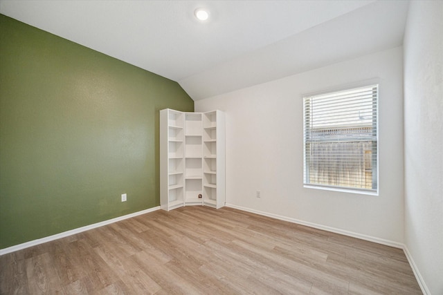 14231 Walworth Creek Ct, Rosharon, TX 77583 - unfurnished room featuring light wood-type flooring, lofted ceiling, and baseboards