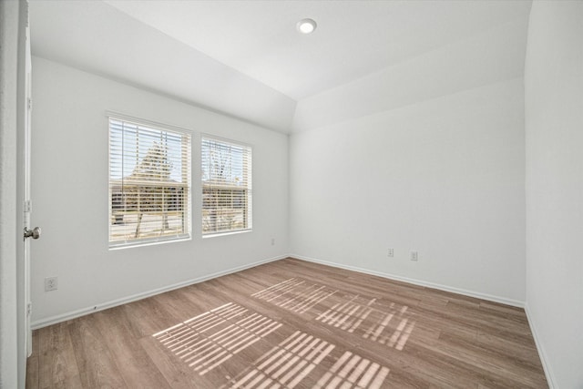 14231 Walworth Creek Ct, Rosharon, TX 77583 - spare room with wood finished floors, baseboards, and lofted ceiling