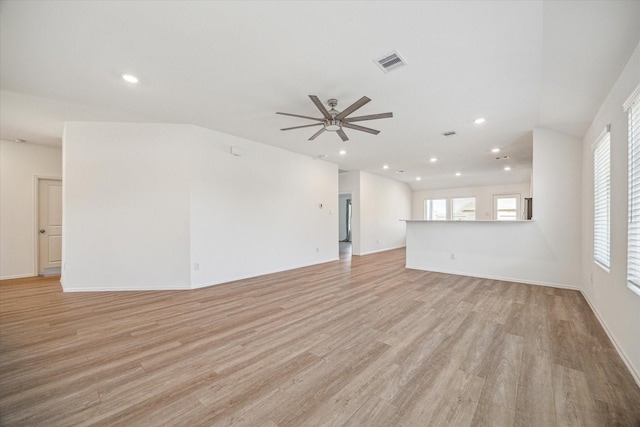 unfurnished living room with ceiling fan and light wood-type flooring