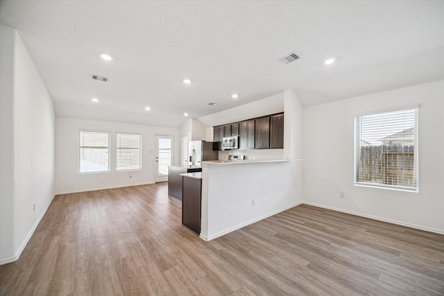 14231 Walworth Creek Ct, Rosharon, TX 77583 - kitchen with stainless steel microwave, refrigerator with ice dispenser, healthy amount of natural light, light wood-style flooring, and recessed lighting