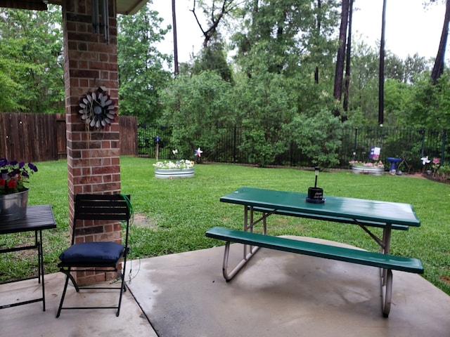 view of community featuring a yard and a patio area