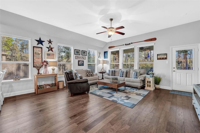 living room with dark wood-type flooring, ceiling fan, and vaulted ceiling