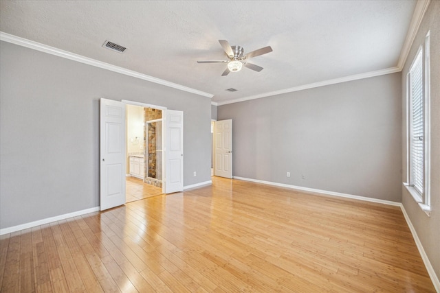 empty room featuring light wood-style floors, baseboards, a ceiling fan, and ornamental molding