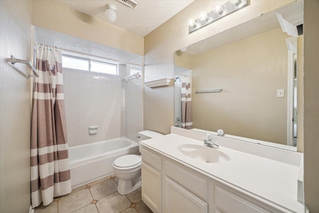 full bath with toilet, shower / bath combo, vanity, a textured ceiling, and tile patterned floors