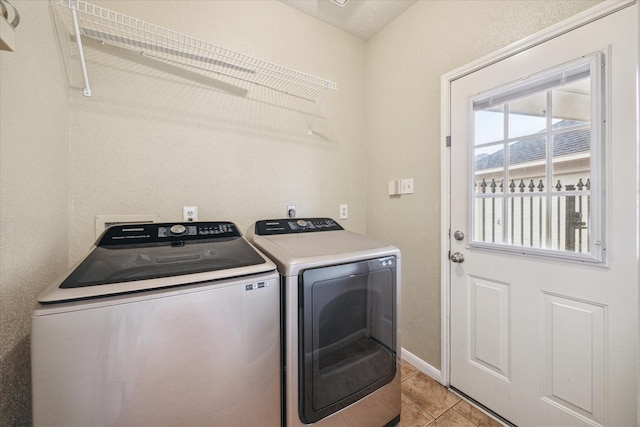 washroom featuring laundry area, light tile patterned floors, and separate washer and dryer