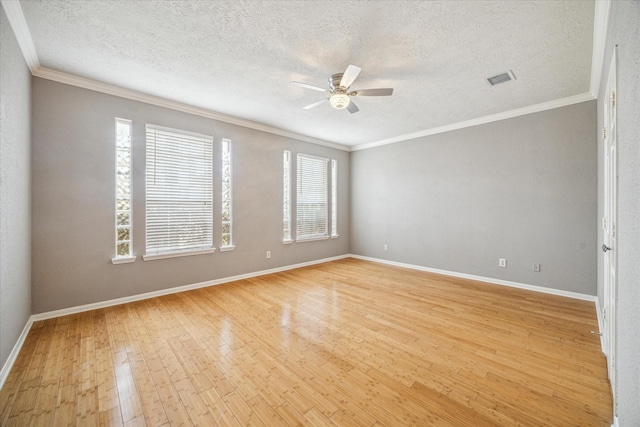 unfurnished room with ceiling fan, light wood-type flooring, baseboards, and crown molding