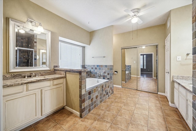 full bathroom featuring a ceiling fan, tile patterned flooring, vanity, and a bath