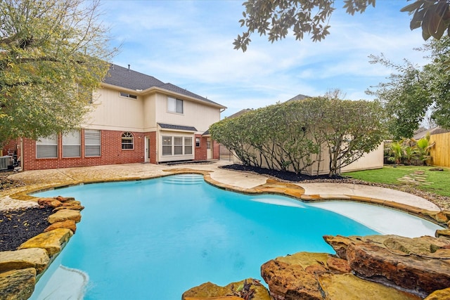 view of swimming pool with a fenced backyard, a fenced in pool, central AC, and a patio