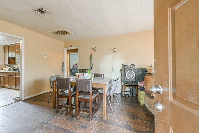 dining area with dark hardwood / wood-style flooring