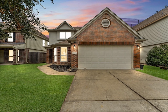 view of property with a garage and a yard